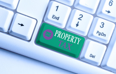 Word writing text Property Tax. Business photo showcasing an ad valorem tax on the value of a property Millage rate White pc keyboard with empty note paper above white background key copy space