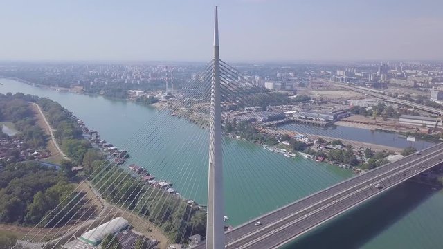 Breathtaking 4k aerial orbiting establishing shot of Sava river and Ada bridge in Belgrade