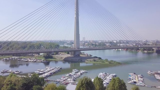 Ascending 4k aerial shot revealing Ada bridge in Belgrade and Ada lake