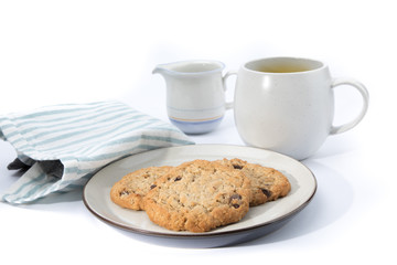 oatmeal raisin cookies on a plate with a cup of coffee isolated on white
