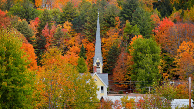 Church steeple between autumn trees in east Royalton Vermont