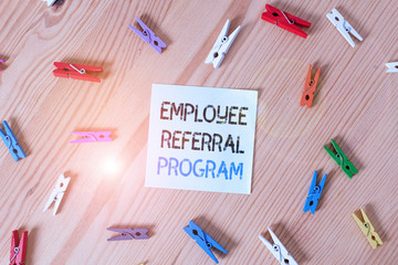 Writing note showing Employee Referral Program. Business concept for employees recommend qualified friends relatives Colored clothespin papers empty reminder wooden floor background office