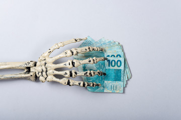 Economic situation of Brazil concept, Skeleton stealing money.