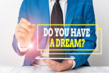 Conceptual hand writing showing Do You Have A Dream Question. Concept meaning asking someone about life goals Achievements Businessman pointing with pen in empty copy space