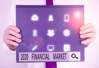 Text sign showing 2020 Financial Market. Business photo text place where trading of equities, bonds, currencies Male human holding thick textured cardboard of business promotion concept