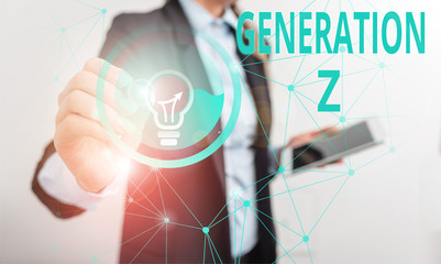 Conceptual hand writing showing Generation Z. Concept meaning name for the generation of children after the millennials Male human wear formal suit presenting using smart device