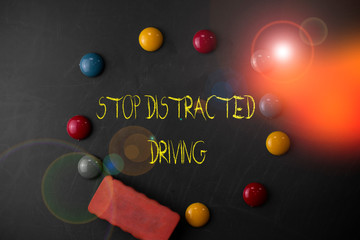 Word writing text Stop Distracted Driving. Business photo showcasing asking to be careful behind wheel drive slowly Round Flat shape stones with one eraser stick to old chalk black board