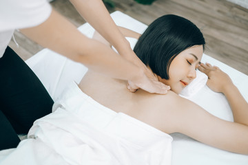 Beautiful young woman lying down on beds massage and spa at asian spa massage and beauty salon center, spa concept, massage concept