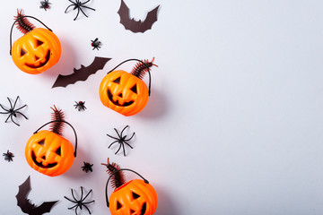 Halloween and decoration concept, Pumpkin with face, spiders, bats and centipede on gray background.