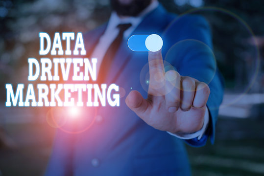 Text sign showing Data Driven Marketing. Business photo text Strategy built on Insights Analysis from interactions Male human wear formal work suit presenting presentation using smart device