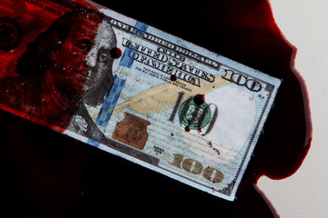 100 dollars banknote drowned in a pool of blood