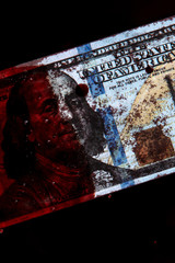 100 dollars banknote drowned in a pool of blood