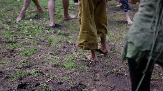 Diverse people enjoy spiritual gathering Barefooted people are seen in slow-mo, experiencing a free state of mind through slow flowing movements during multicultural celebration in a sacred forest.