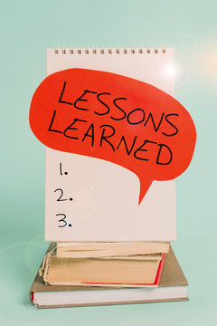 Writing note showing Lessons Learned. Business concept for the knowledge or understanding gained by experience Spiral notebook speech bubble stacked old books cool pastel background
