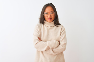 Young chinese woman wearing turtleneck sweater and glasses over isolated white background skeptic and nervous, disapproving expression on face with crossed arms. Negative person.