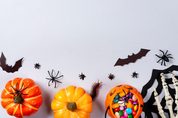 Halloween and decoration concept, Pumpkins, web, bats, spiders, centipede and flies on gray...
