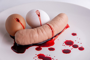 vegetarian propaganda, concept: bleeding sausage and cracked eggs, short focus