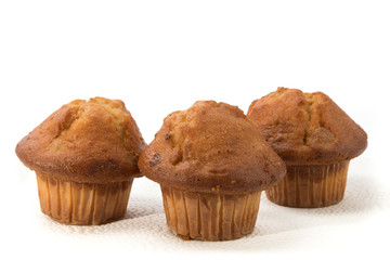 a group of golden lemon cranberry muffins isolated on white