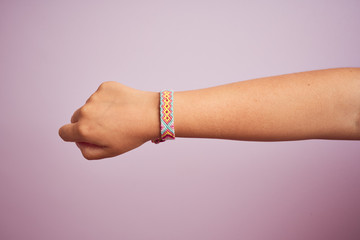 Model arm with beautiful handmade colorful bracelet on wrist