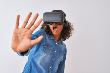Young african american teenager girl playing virtual reality game using goggles