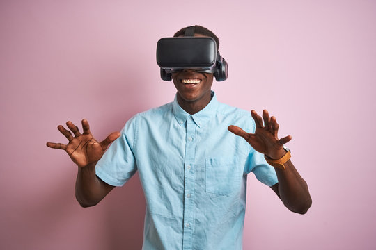 Young african american man playing virtual reality game using goggles