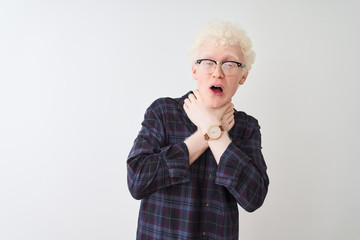 Young albino blond man wearing casual shirt and glasses over isolated white background shouting and suffocate because painful strangle. Health problem. Asphyxiate and suicide concept.