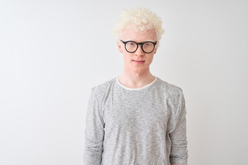 Young albino blond man wearing striped t-shirt and glasses over isolated white background Relaxed with serious expression on face. Simple and natural looking at the camera.