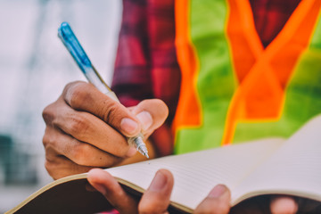 Close up hand take write notebook work plan