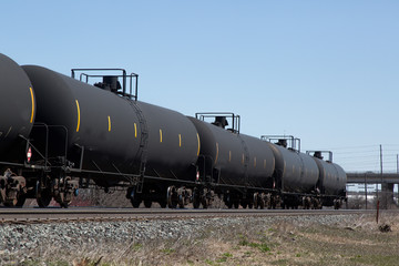 unidentified black railroad oil tank car train