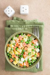 Fresh homemade vegetarian Russian or Olivier salad made of potato, carrot, pea, hard-boiled egg and...