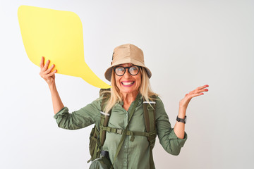 Senior hiker woman wearing canteen holding speech bubble over isolated white background very happy and excited, winner expression celebrating victory screaming with big smile and raised hands