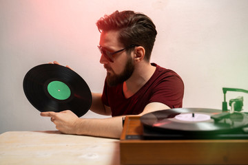Hipster man holding music record 