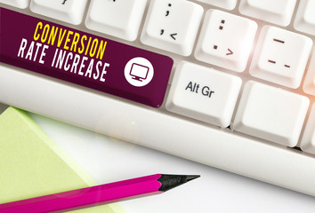 Writing note showing Conversion Rate Increase. Business concept for Ratio of Total Visitors who perform desired actions White pc keyboard with note paper above the white background