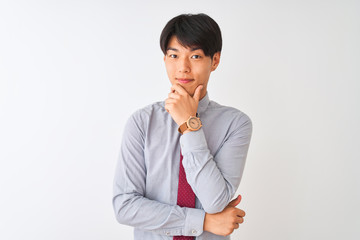 Chinese businessman wearing elegant tie standing over isolated white background looking confident at the camera smiling with crossed arms and hand raised on chin. Thinking positive.