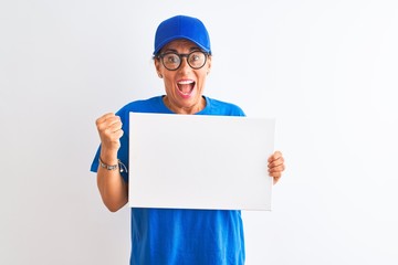 Senior deliverywoman wearing cap and glasses holding banner over isolated white background screaming proud and celebrating victory and success very excited, cheering emotion