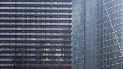 mixed zoning urban area. High rise residential building and skyscraper office building side by side. modern multistorey curtain wall architecture. steel frame and glass cladding construction.