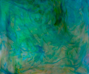 Blurred photo of food color drop and dissolve in water for background and texture concept.