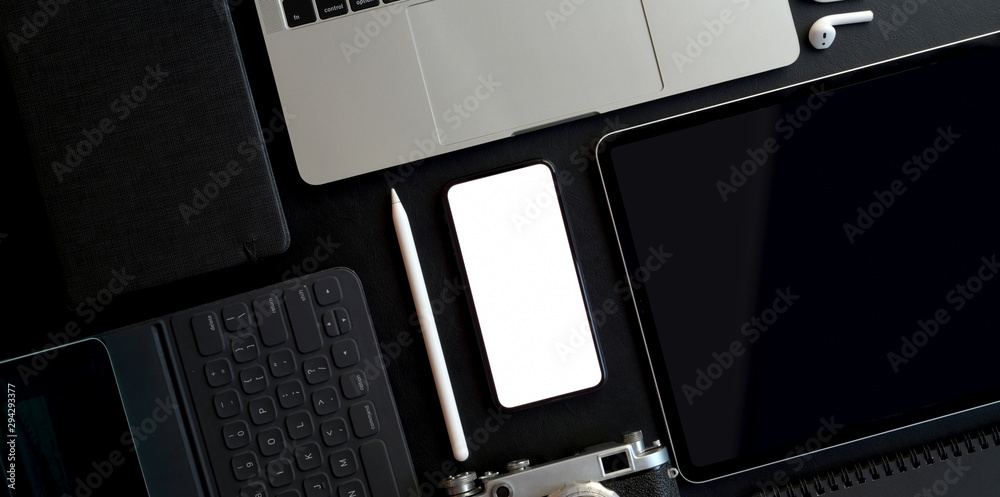Poster top view of dark trendy workspace with blank screen smartphone and other electronics with office sup