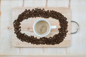 Coffee beans surrounded the coffee cup