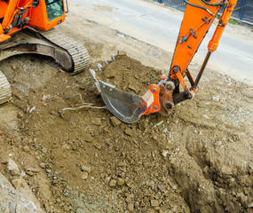 xcavator digging a ditch on the construction site.