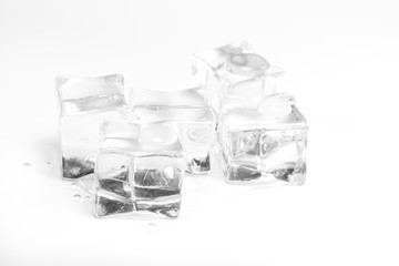 Wet ice cubes isolated on white background.Heap of melting ice on the plate.