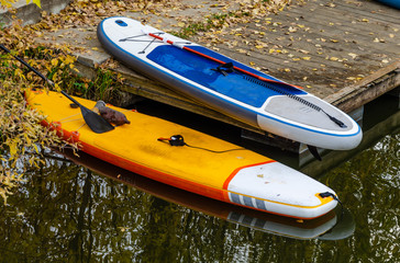 sup boards for swimming on the pier on the river Bank.