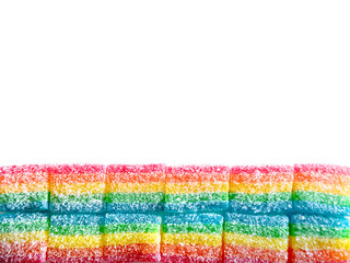 ribbon of rainbow candy at the bottom of the frame on a white background
