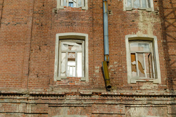 Old brick wall in the house .Rusty drainpipe.
