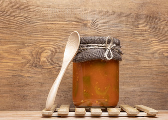 lecho in a jar on a wooden background