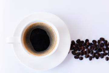 Top view of hot coffee and foam in white cup with coffee beans isolated on white background and copy space.Coffee menu in the coffee shop or restaurant.