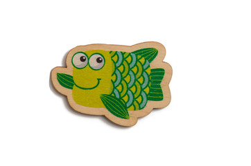 wooden toy green fish on a white isolated background