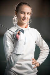 A portrait of a young woman fencer with a sword
