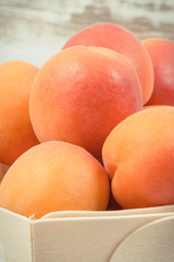 Fresh apricot in wooden box as healthy snack or dessert containing vitamins
