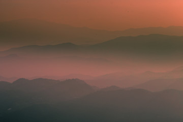 Wide natural background blurred by the bright sunlight above the mountains during the reversal of the horizon, beautiful twilight light, cold wind blowing through, fresh air